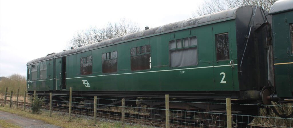 Generator carriage 3223 running as part of a passenger train.