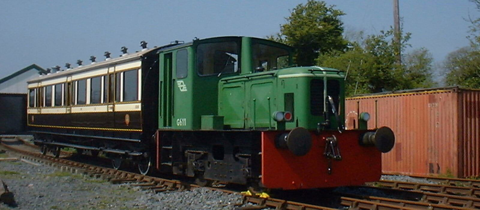 G611 next to a restored carriage in the locomotive yard.